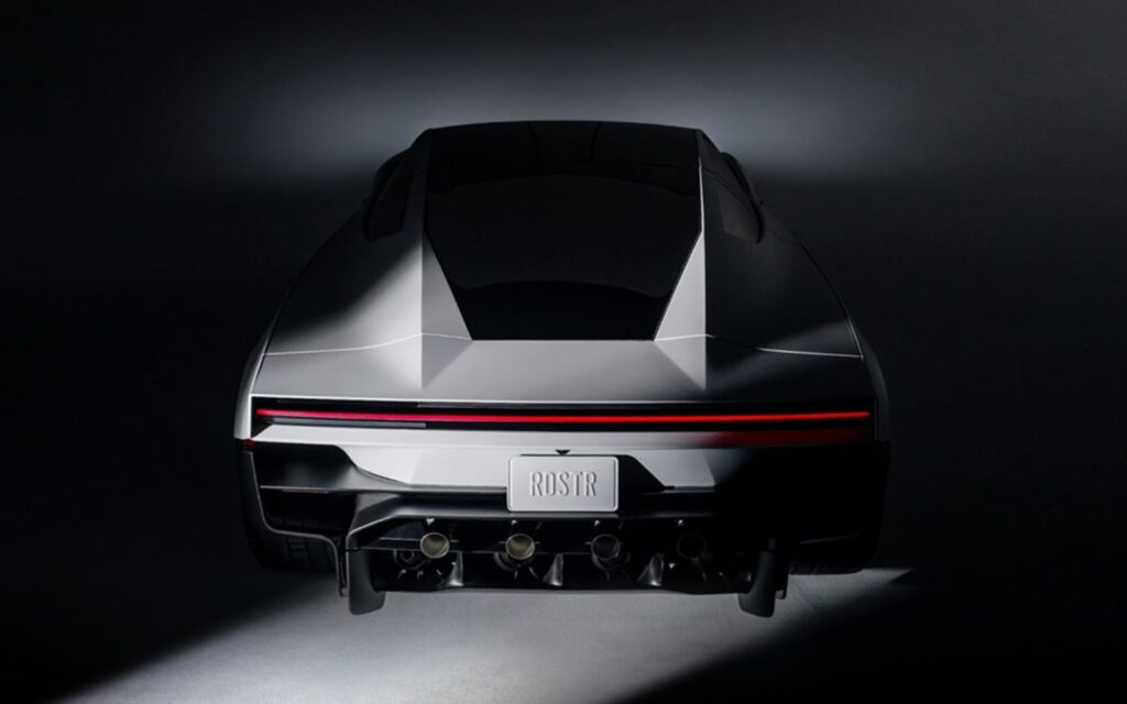 Rear view of the Tesla Roadster lit from below against a dark background