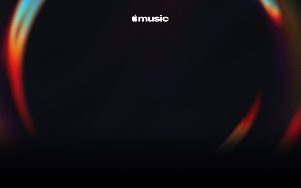 The new Apple Music wordmark in white inside a ring of blue, red and orange light on black