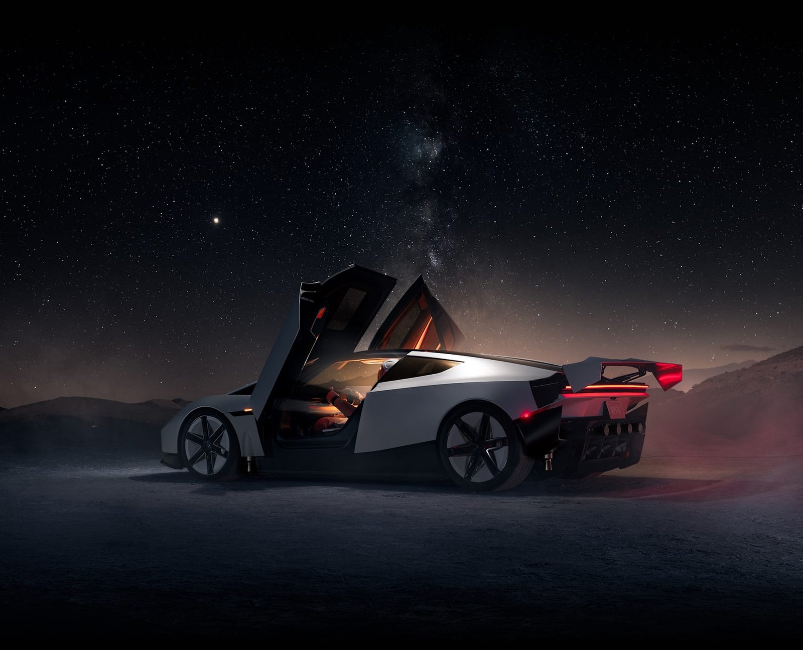 Tesla Roadster at night with doors open under a starry sky