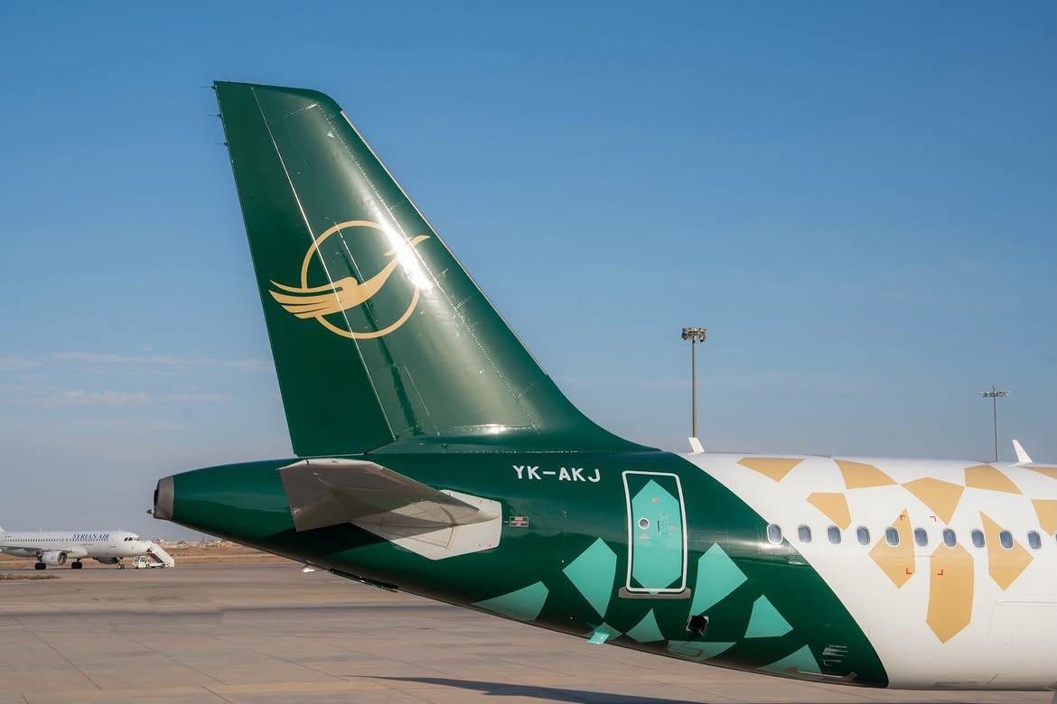 Tail of a Syrian Airlines aircraft with a gold Simurgh bird on dark green and geometric patterns on the fuselage