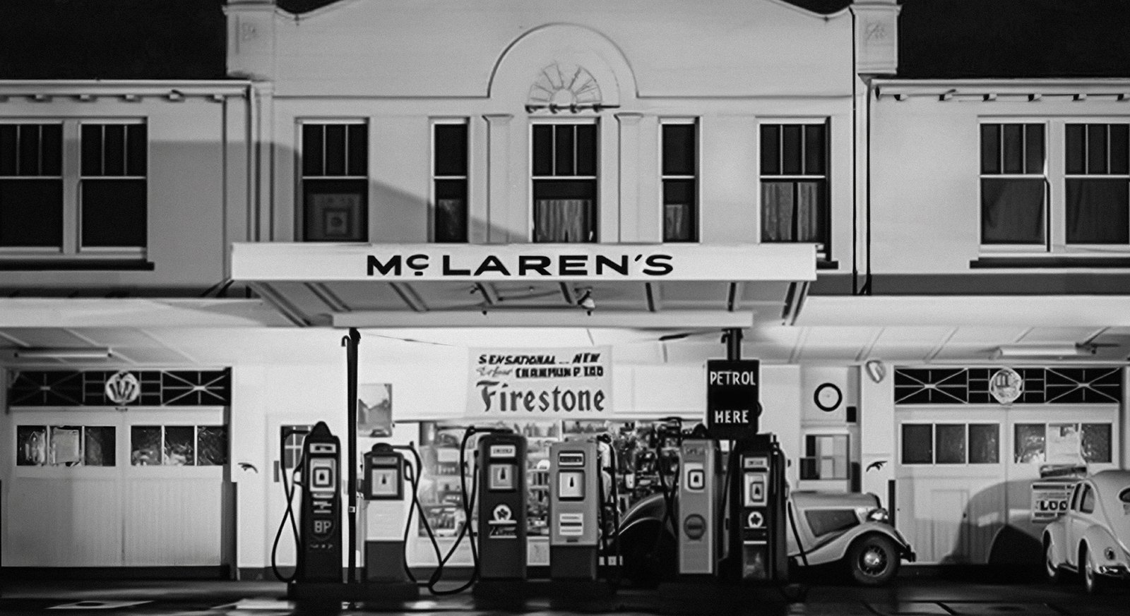 Black and white photo of the McLaren family service station in Remuera, Auckland, with the original sign
