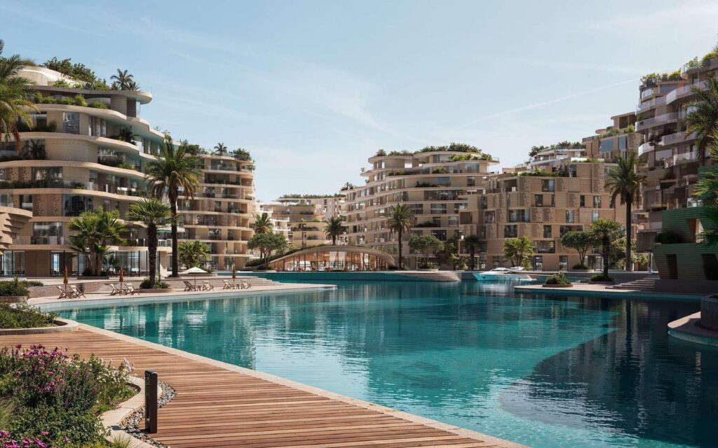 A waterfront promenade and lagoon at THE WADI development in Abu Dhabi